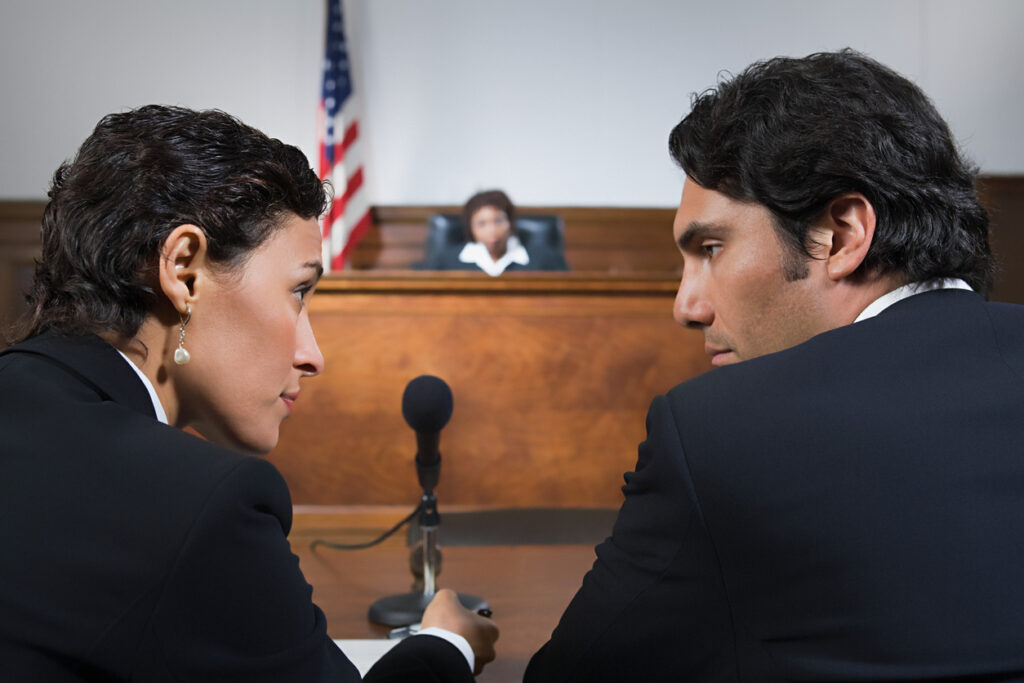 Attorneys with an interpreter in a courtroom